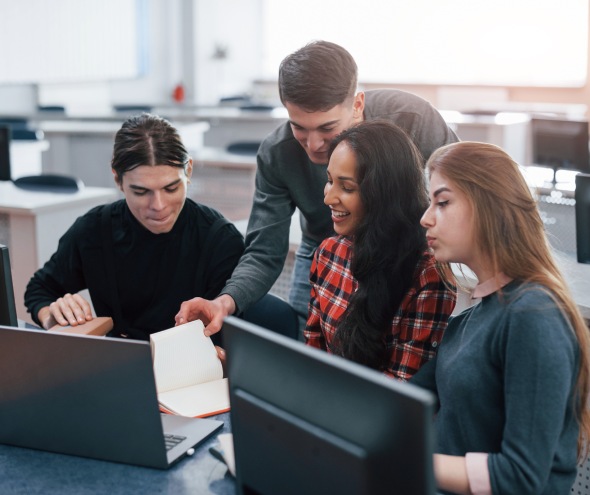 Group of young people in casual clothes working in the modern office